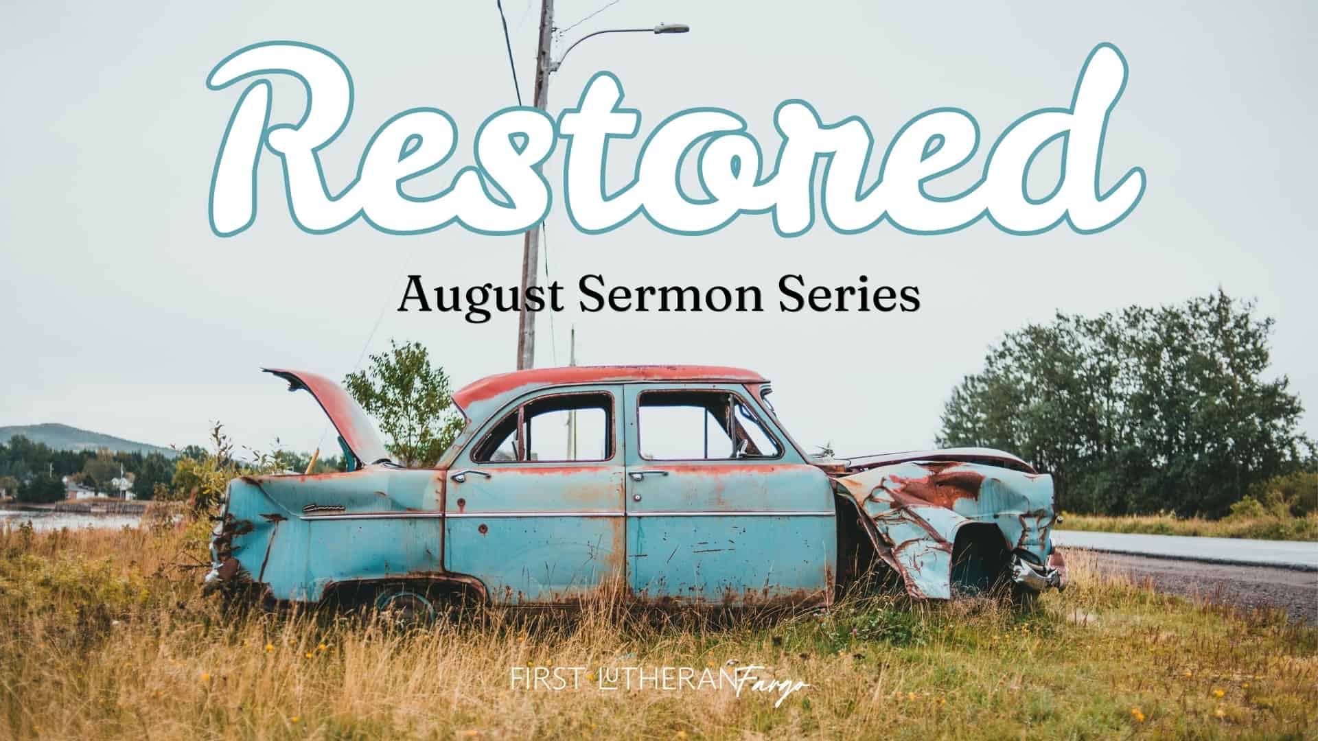 Restored Sermon August Series - an old, rusty car in the grass on the side of a road